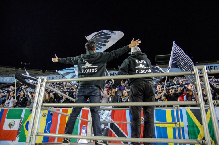 Dark Clouds capos lead cheers during a match.