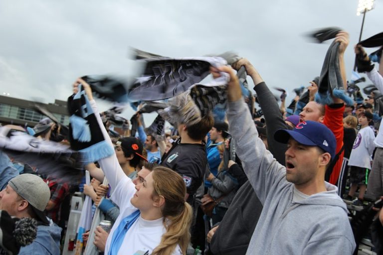 Dark Clouds twirling scarves for a corner kick