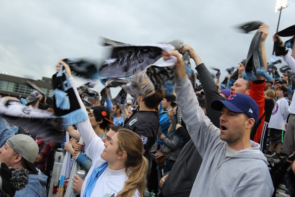 Dark Clouds twirling scarves for a corner kick