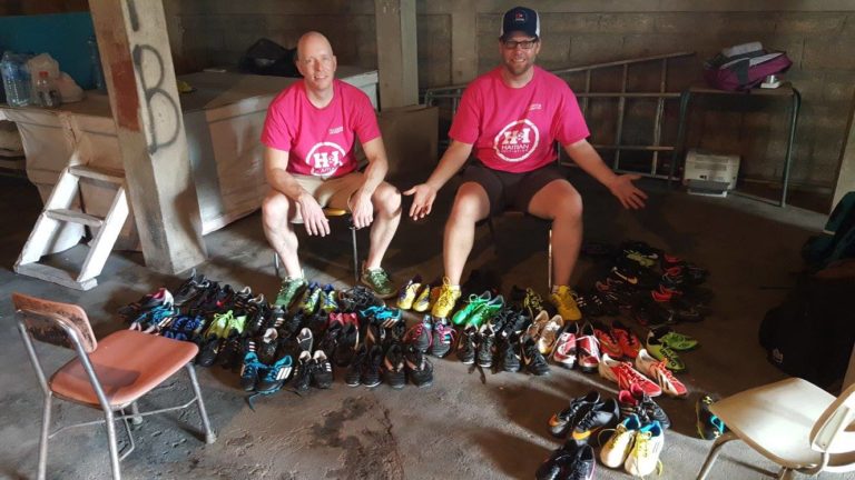 Volunteers Andy Wattenhofer and Rich Harrison pose with some of the gear that was handed out.