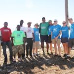Silver Lining Volunteers (in blue t-shirts) with Haitian Initiative staff and Tony Sanneh (in dark green t-shirt with sunglasses).