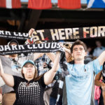 Dark Clouds hold up scarves at MINvHOU on 7/19 (Photo: Daniel Mick)