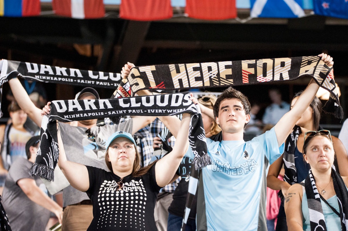 Dark Clouds hold up scarves at MINvHOU on 7/19 (Photo: Daniel Mick)