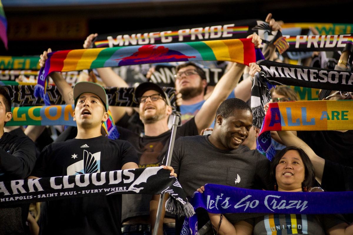 Dark Clouds holding up their scarves. (Photo: Daniel Mick)