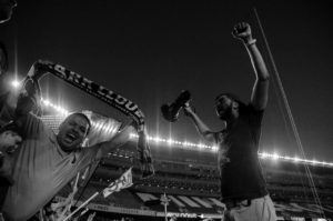 Edson holds a Dark Clouds scarf and Nach holds a megaphone at MINvDCU (Photo: Daniel Mick)