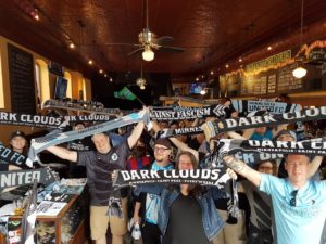 Many members of the Dark Clouds cheering on the team during a watch party at the Nomad World Pub.