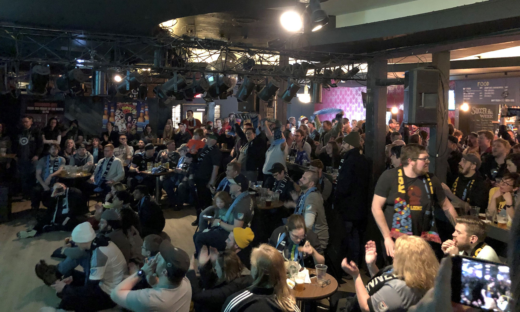 Many members of the Dark Clouds during the first watch party of the season, gathered around a screen at the Black Hart of Saint Paul.