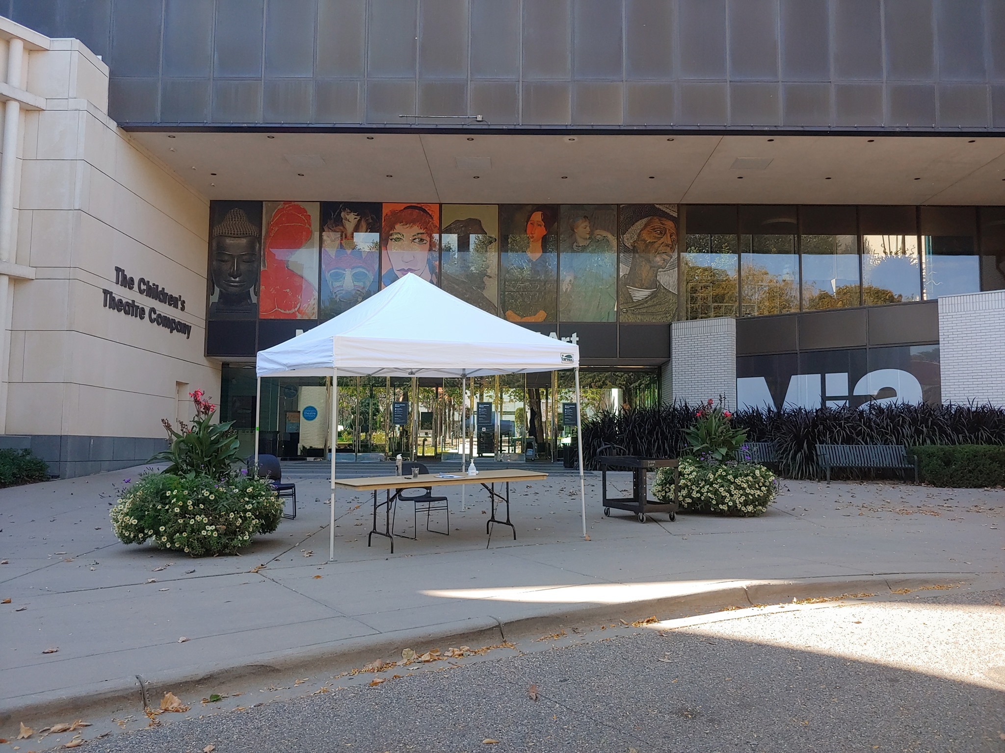 The outside of Children's Theater Company in Minneapolis, with a tent set up for donations.