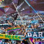 Dark Clouds Flags and Scarves being held up in the Wonderwall